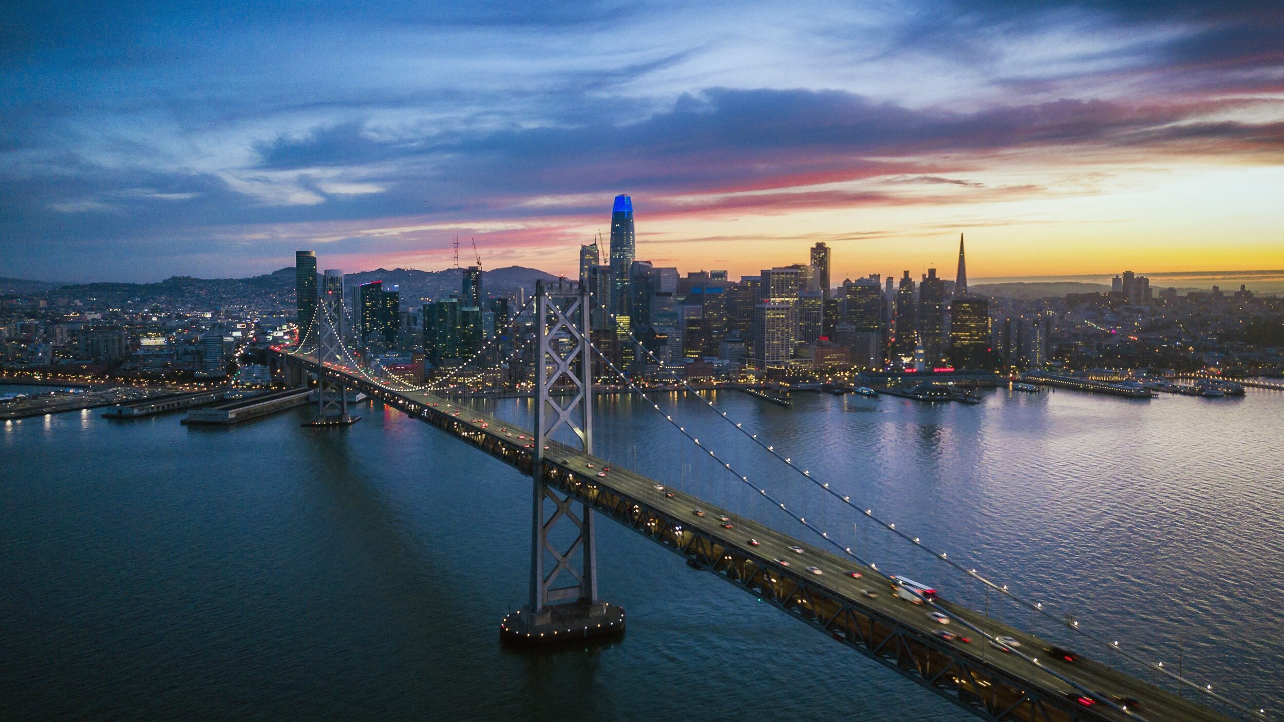 San Francisco skyline with bridge at sunset.